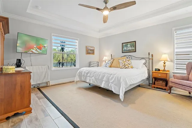 a bedroom with a bed and a chandelier