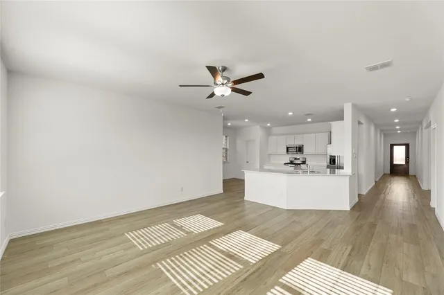 a view of kitchen with cabinets and wooden floor