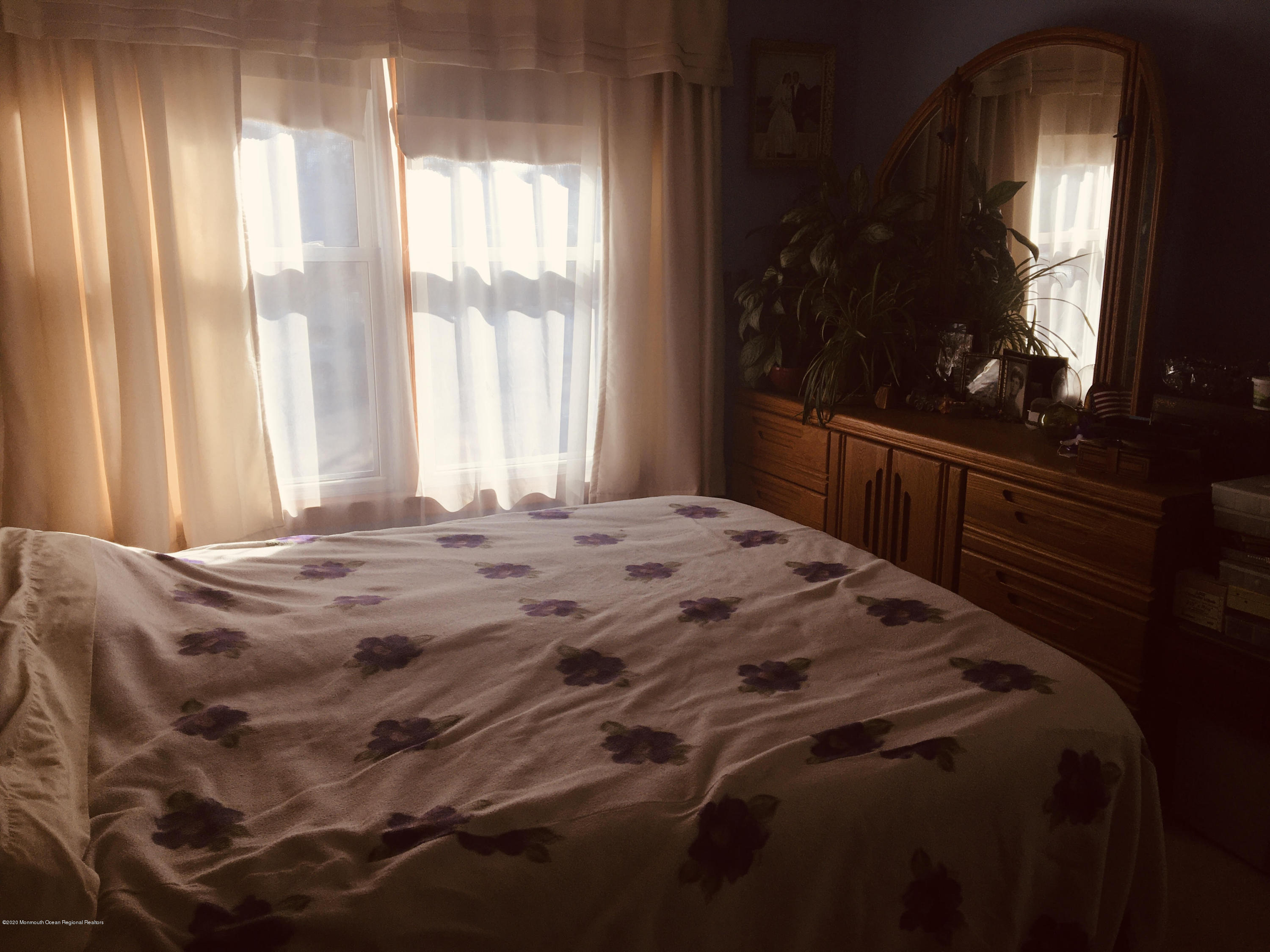 1309 Mossbank Road Point Pleasant, NJ 08742 - Photo 8 of 18 a bedroom with a bed window and mirror