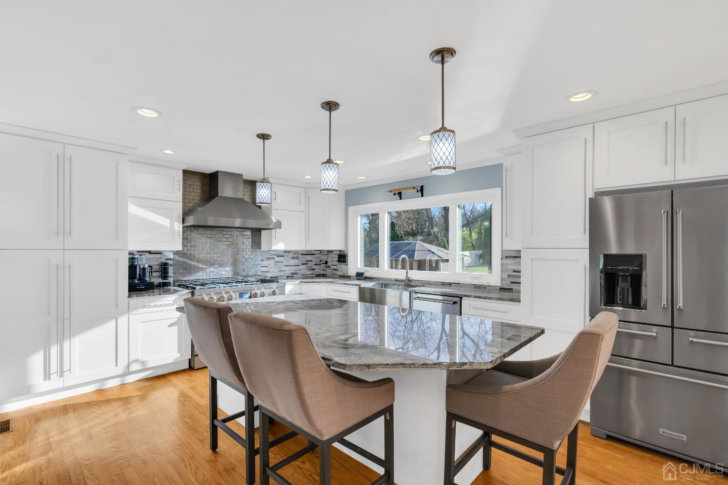 116 Grovers Mill Road Plainsboro, NJ 08536 - Photo 11 of 78 a kitchen with stainless steel appliances granite countertop a dining table chairs stove refrigerator and cabinets