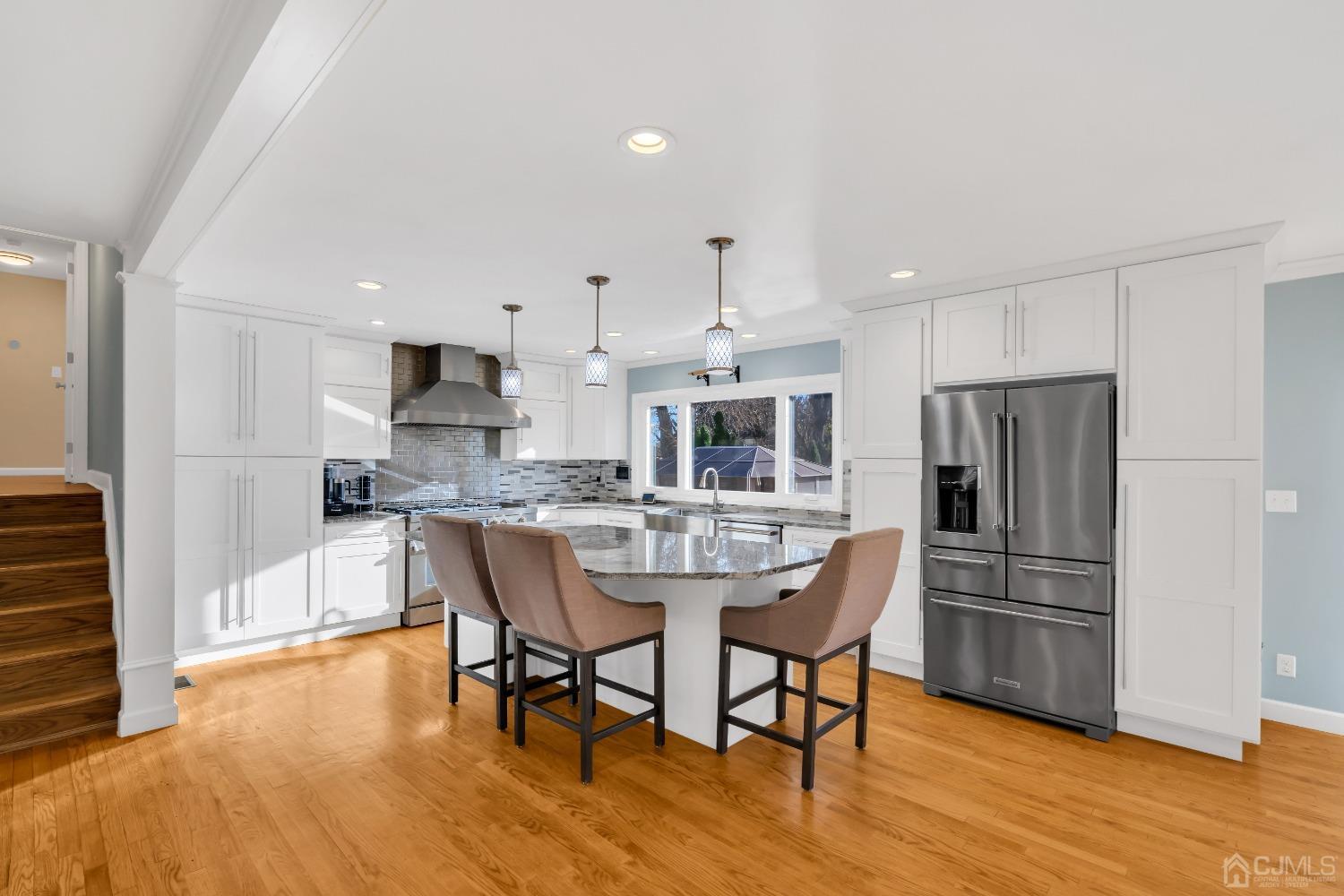 116 Grovers Mill Road Plainsboro, NJ 08536 - Photo 12 of 78 a kitchen with stainless steel appliances a dining table chairs refrigerator and sink