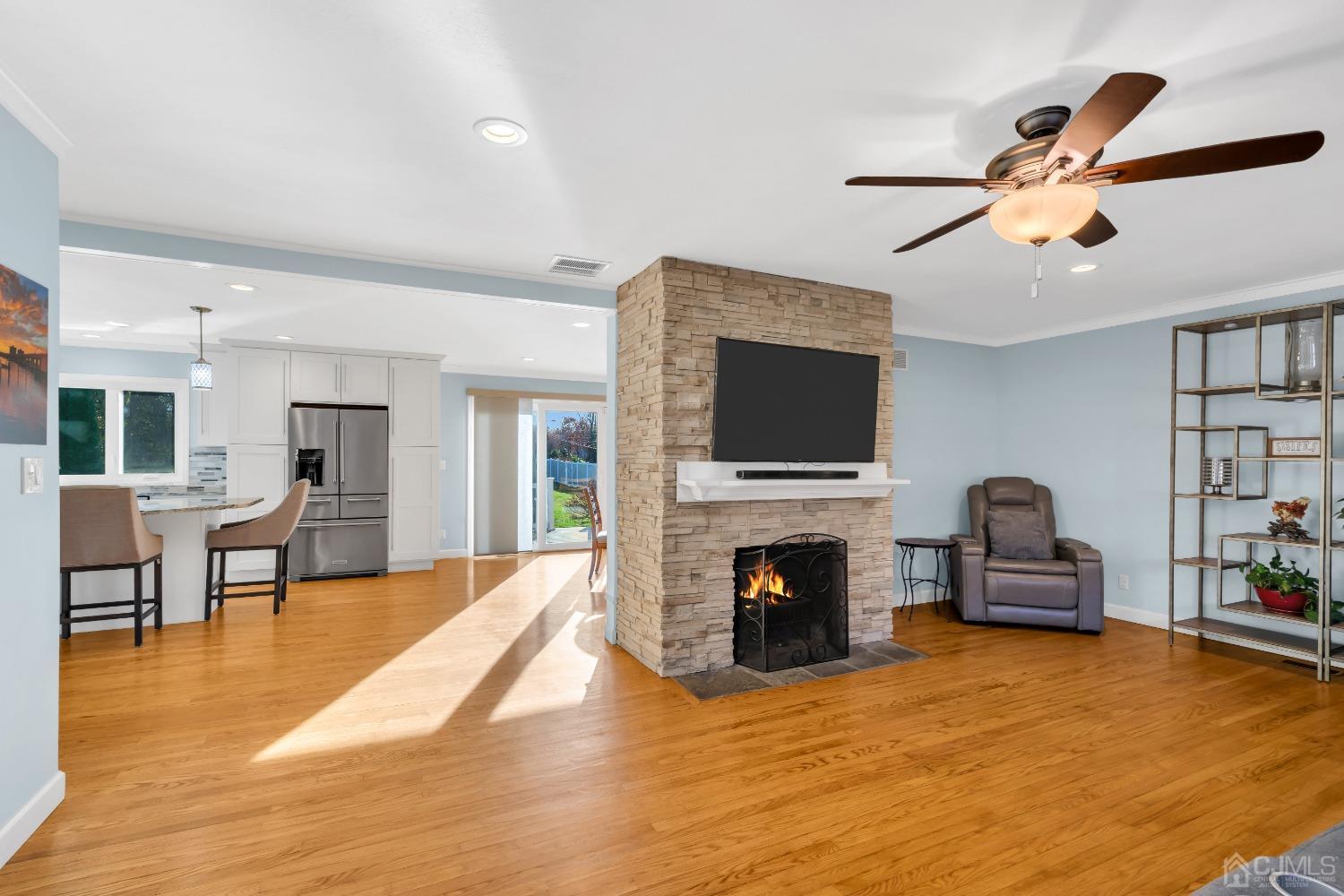 116 Grovers Mill Road Plainsboro, NJ 08536 - Photo 18 of 78 a living room with furniture a flat screen tv and a fireplace