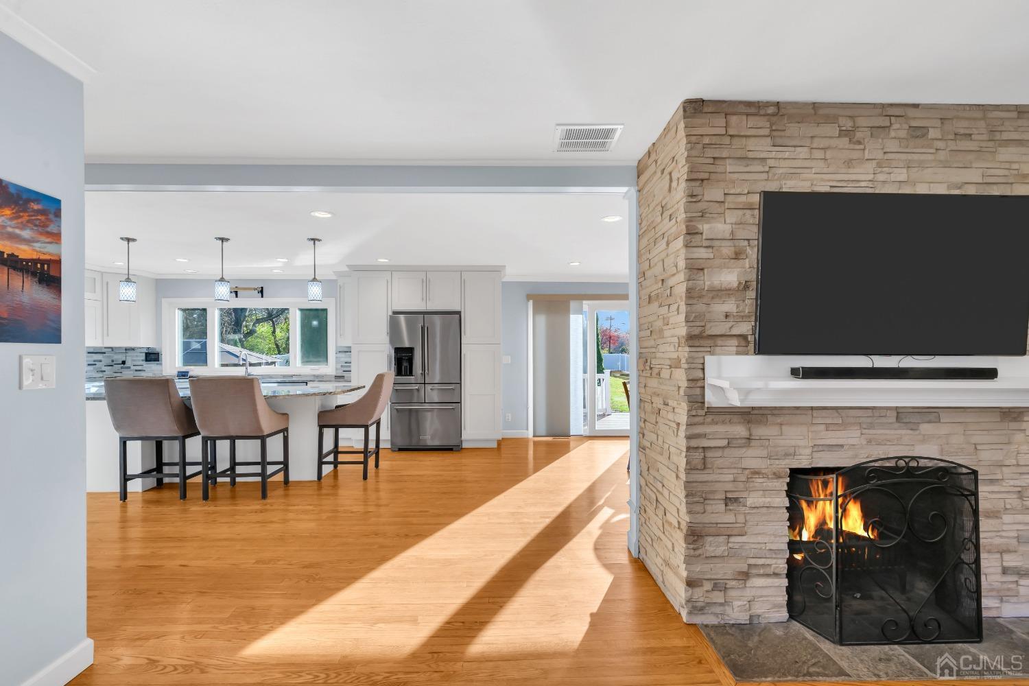 116 Grovers Mill Road Plainsboro, NJ 08536 - Photo 19 of 78 a living room with furniture a flat screen tv and a fireplace