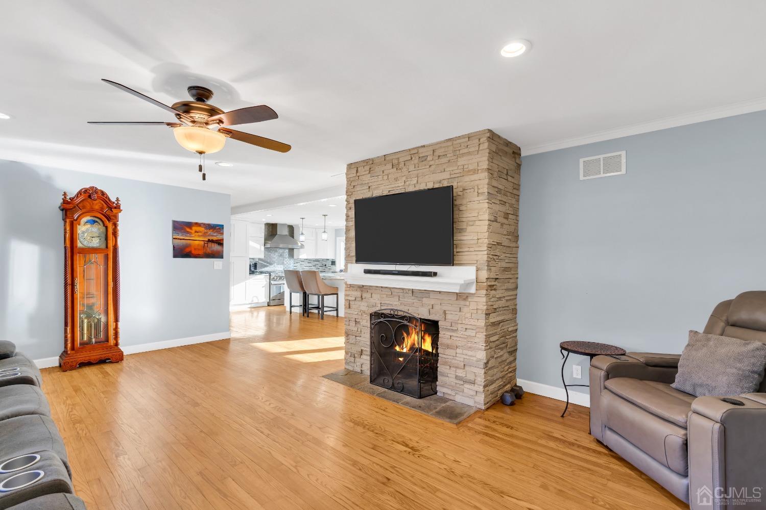 116 Grovers Mill Road Plainsboro, NJ 08536 - Photo 21 of 78 a living room with furniture a flat screen tv and a fireplace