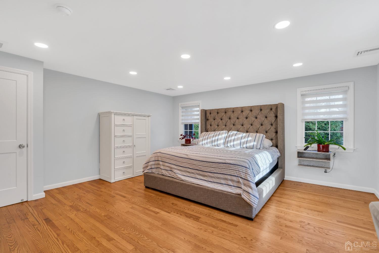 116 Grovers Mill Road Plainsboro, NJ 08536 - Photo 31 of 78 a spacious bedroom with a large bed and a couch