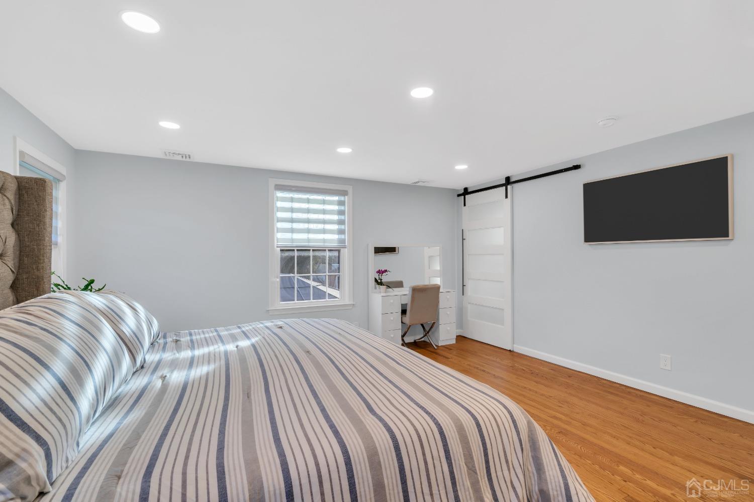 116 Grovers Mill Road Plainsboro, NJ 08536 - Photo 33 of 78 a bedroom with a bed and a flat screen tv