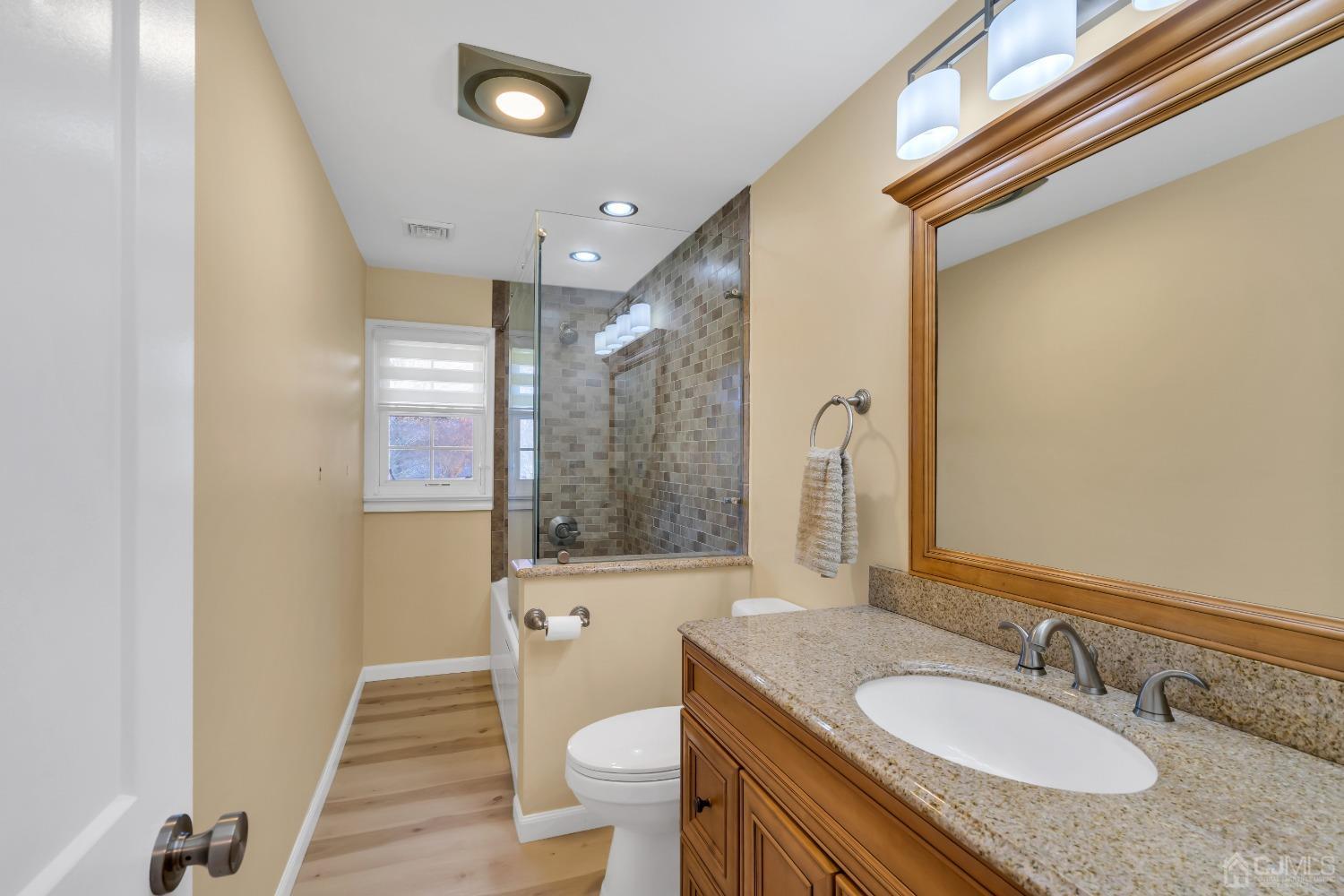 116 Grovers Mill Road Plainsboro, NJ 08536 - Photo 44 of 78 a bathroom with a granite countertop sink toilet a mirror and shower