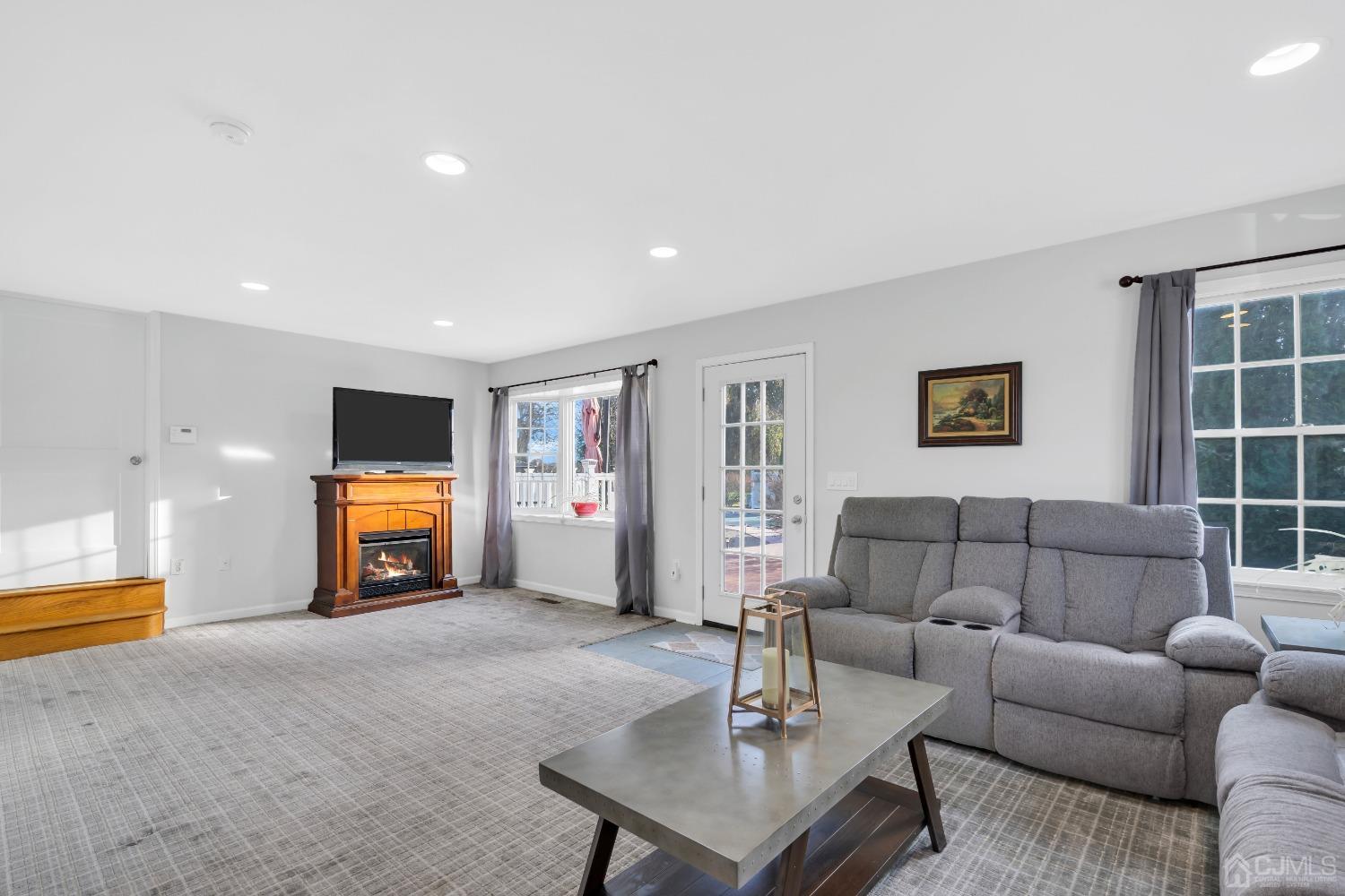 116 Grovers Mill Road Plainsboro, NJ 08536 - Photo 47 of 78 a living room with furniture and a flat screen tv
