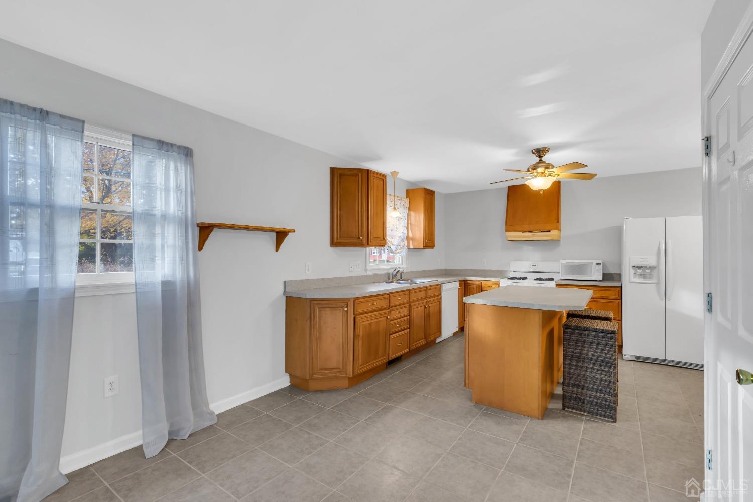 116 Grovers Mill Road Plainsboro, NJ 08536 - Photo 51 of 78 a kitchen with stainless steel appliances granite countertop a sink and a refrigerator