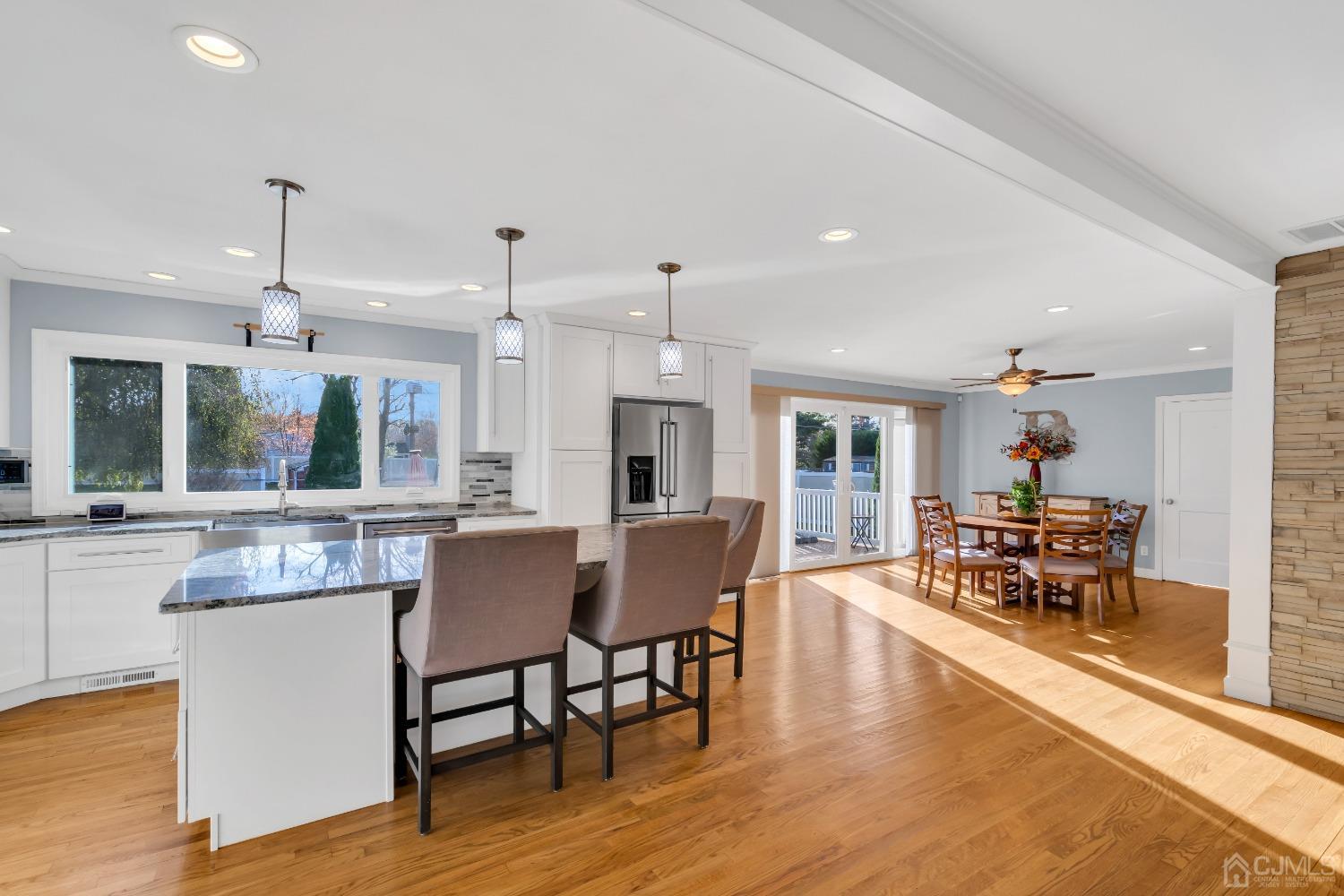116 Grovers Mill Road Plainsboro, NJ 08536 - Photo 6 of 78 a dining room with wooden floor a chandelier a glass table and chairs