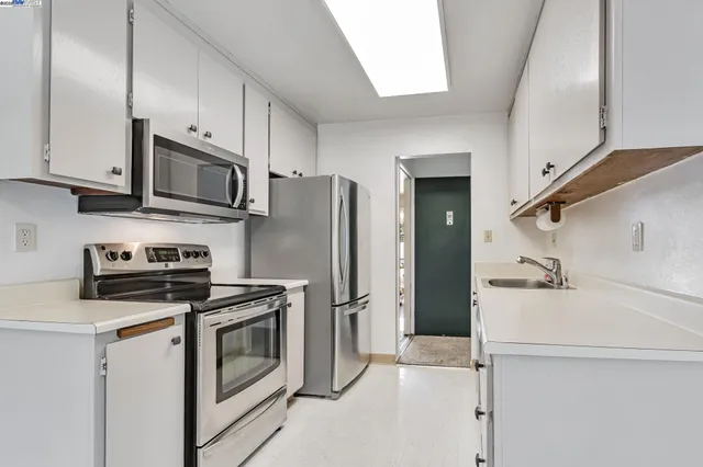 a kitchen with a refrigerator stove and microwave