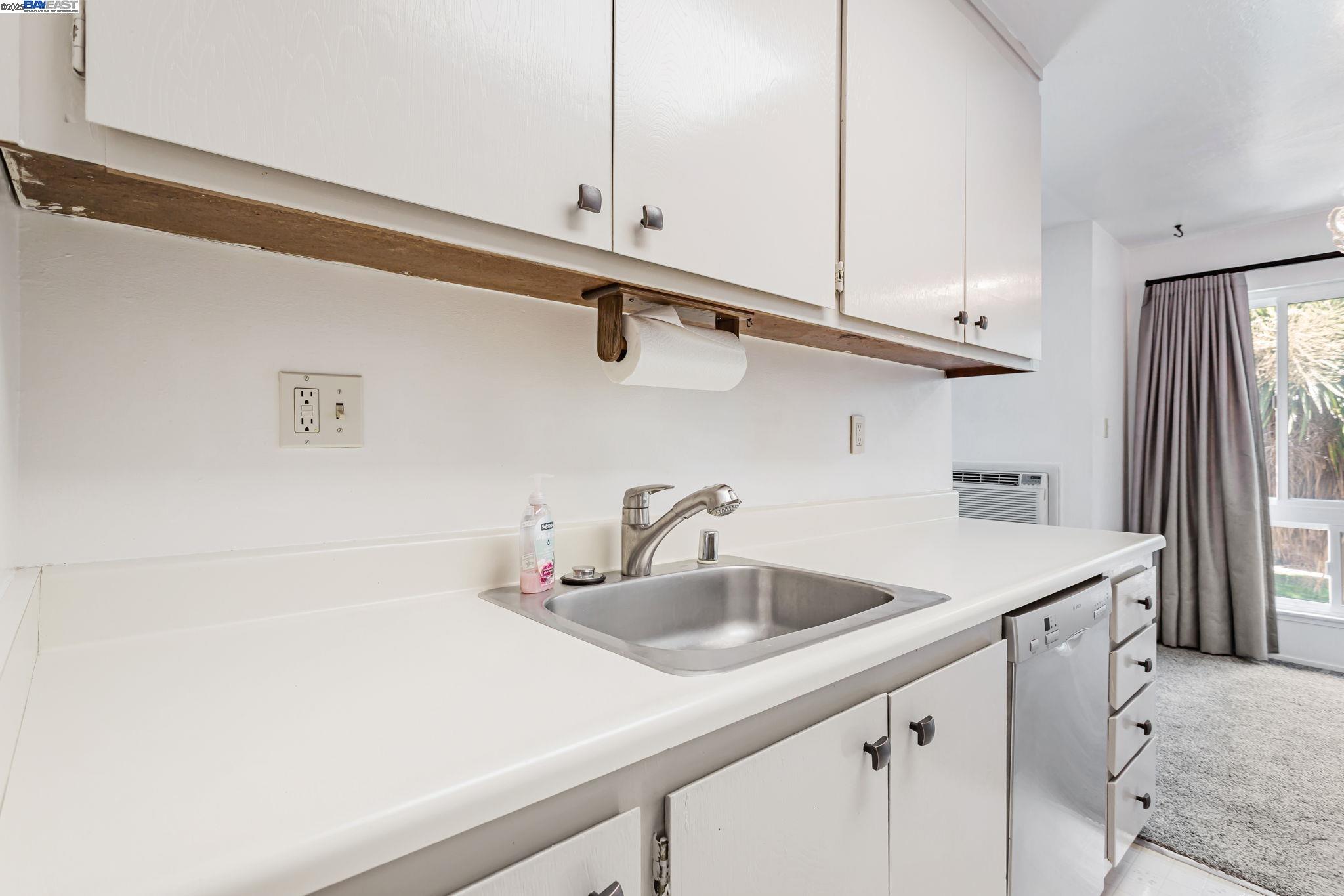 8975 Alcosta Boulevard, Unit 104 San Ramon, CA 94583 - Photo 19 of 42 a kitchen with a sink and cabinets