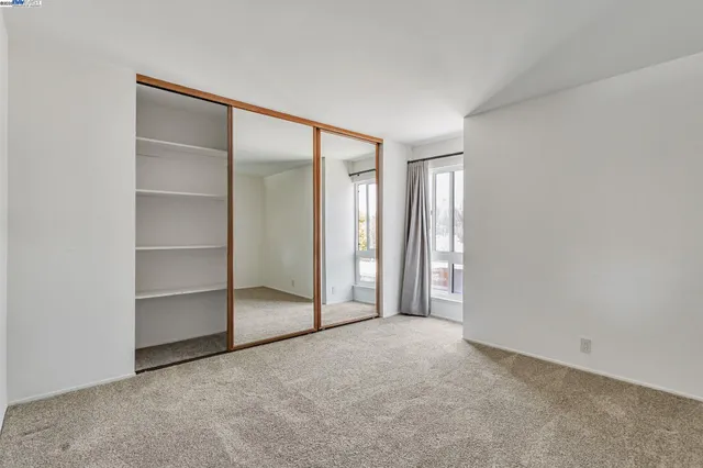 a view of an empty room with a closet