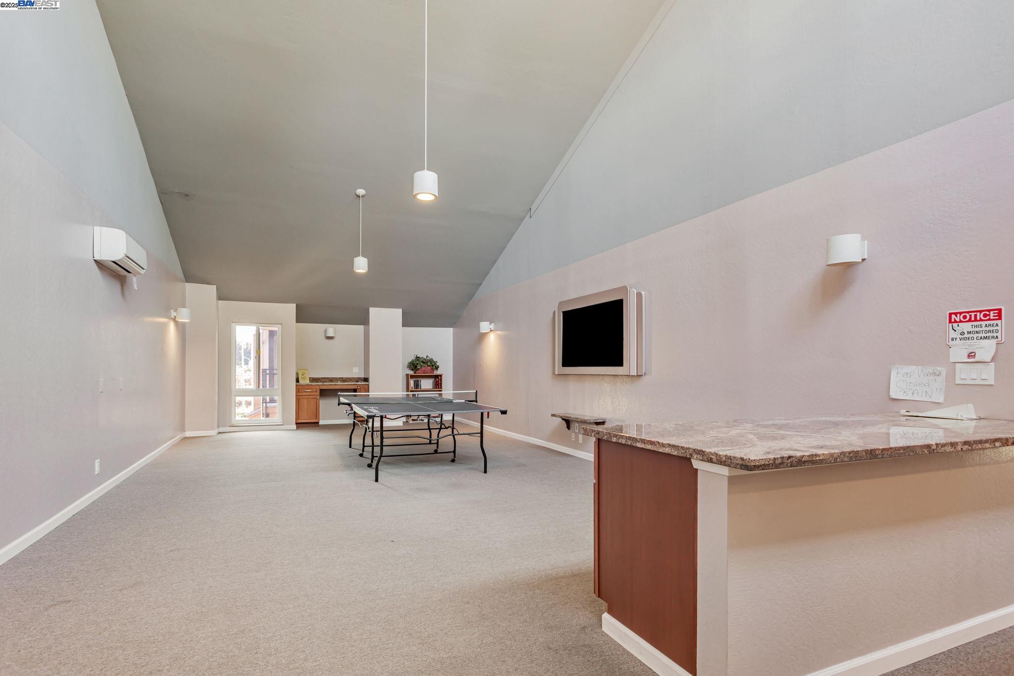 8975 Alcosta Boulevard, Unit 104 San Ramon, CA 94583 - Photo 35 of 42 a view of kitchen with kitchen island stainless steel appliances refrigerator stove microwave and chair