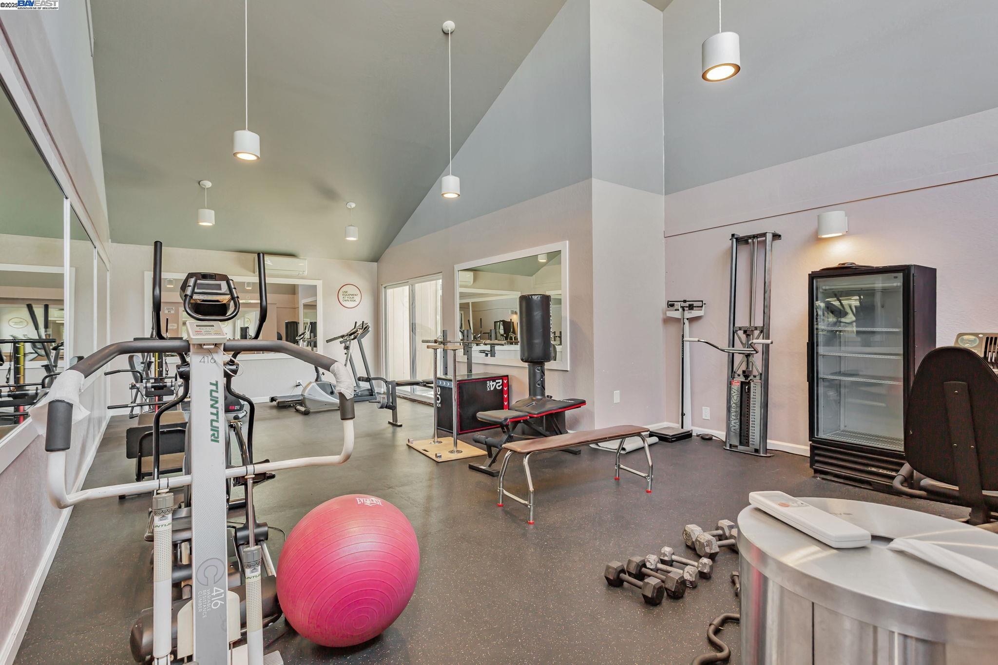 8975 Alcosta Boulevard, Unit 104 San Ramon, CA 94583 - Photo 38 of 42 a room with gym equipment and large mirror