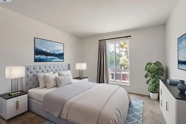 a bedroom with a large bed and a potted plant