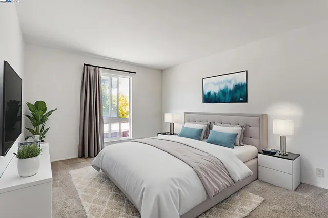 a bedroom with a bed and a potted plant