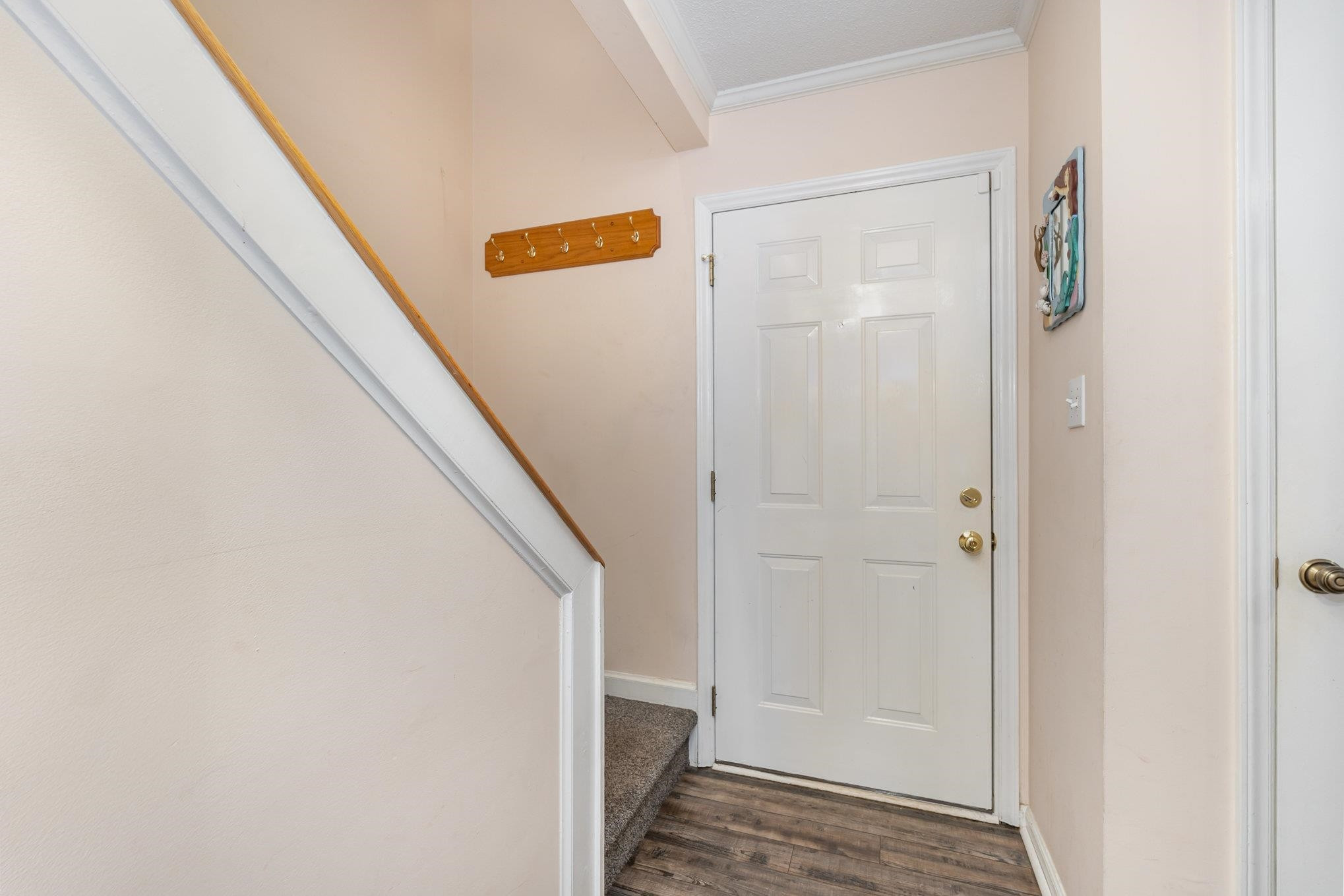 645 Springview Trail Garner, NC 27529 - Photo 2 of 3 a view of hallway with stairs and wooden floor