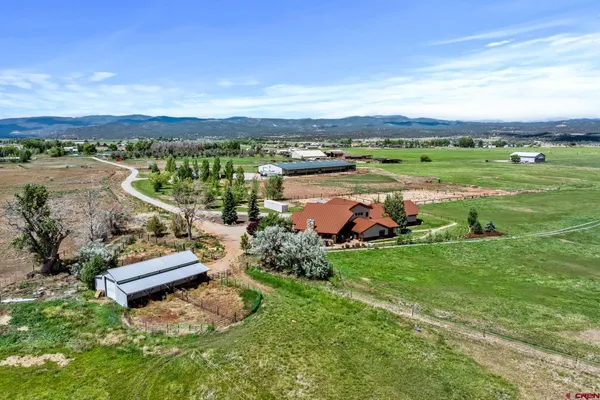 an aerial view of a houses with outdoor space and lake view