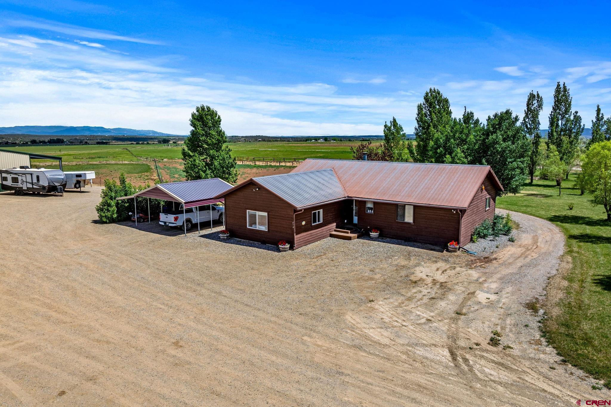 616 Cole Ranch Road Durango, CO 81303 - Photo 13 of 43 a view of a house with big yard and a large tree