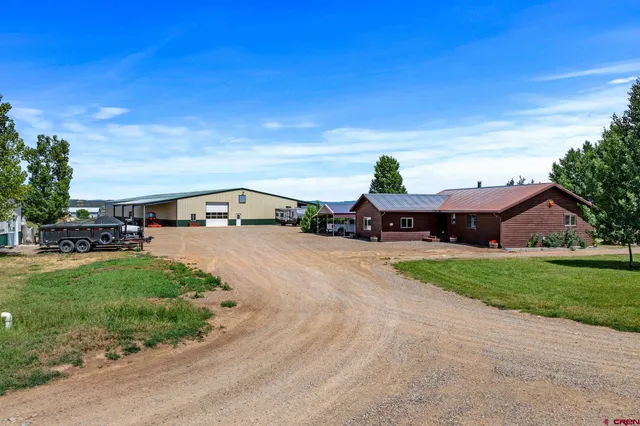 a view of backyard of house and car parked