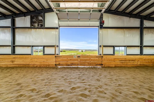a view of a patio with a table and chairs under an umbrella