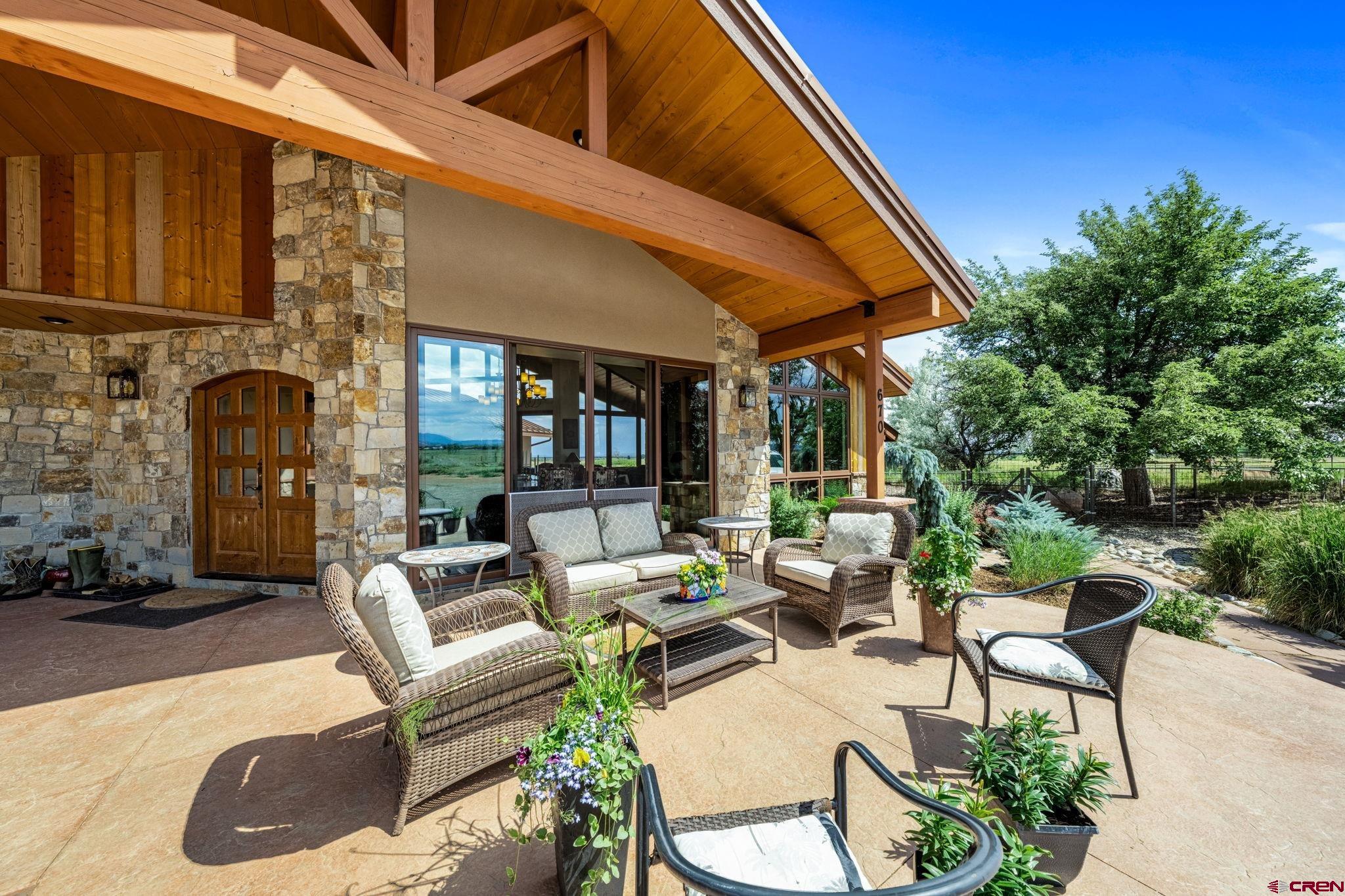 616 Cole Ranch Road Durango, CO 81303 - Photo 18 of 43 a view of a patio with a table and chairs under an umbrella