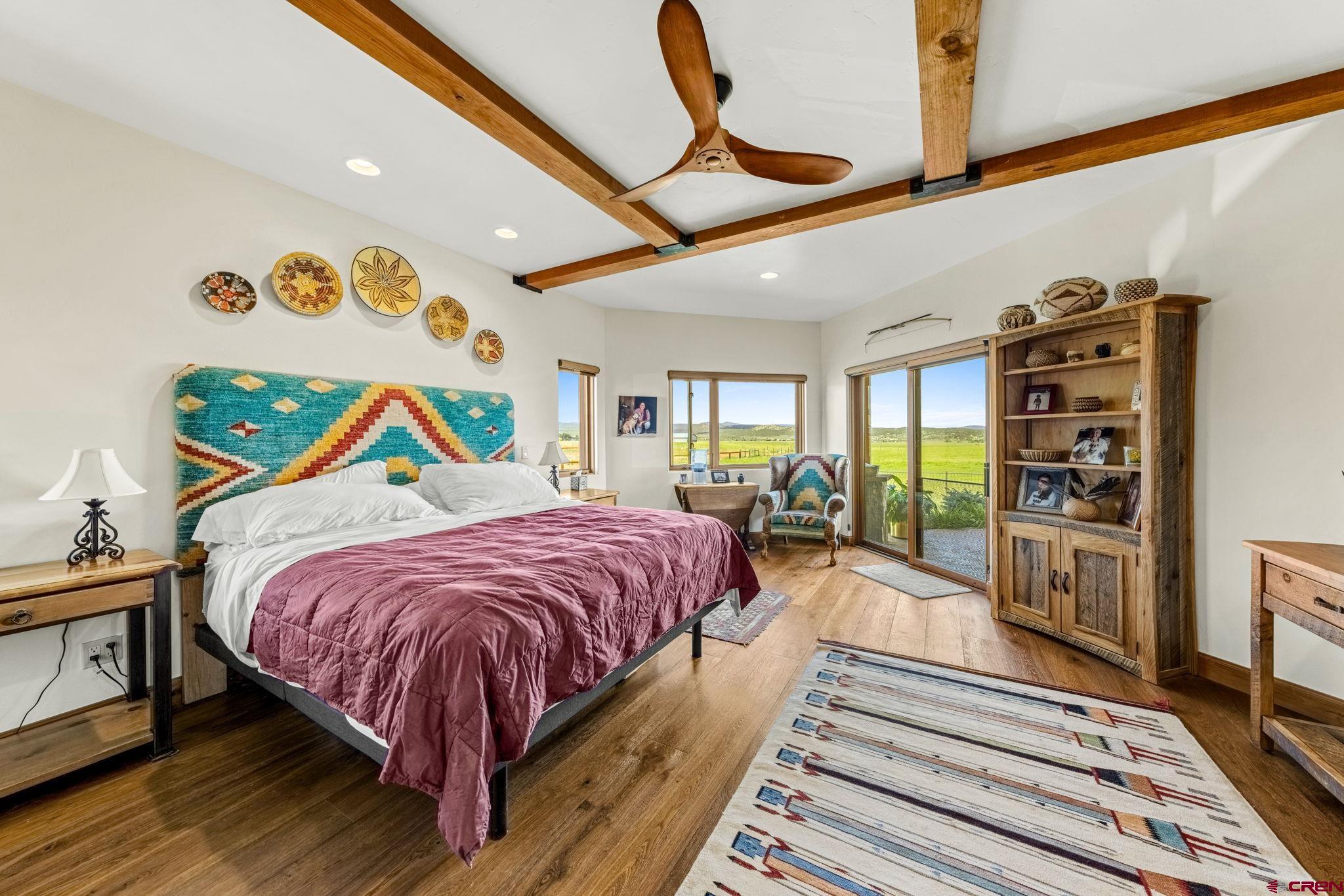 616 Cole Ranch Road Durango, CO 81303 - Photo 29 of 43 a bed room with a bed and a painting on the wall