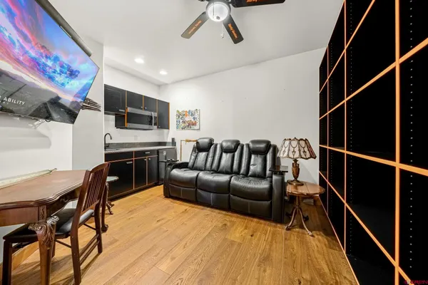 a large kitchen with kitchen island granite countertop a large window and stainless steel appliances