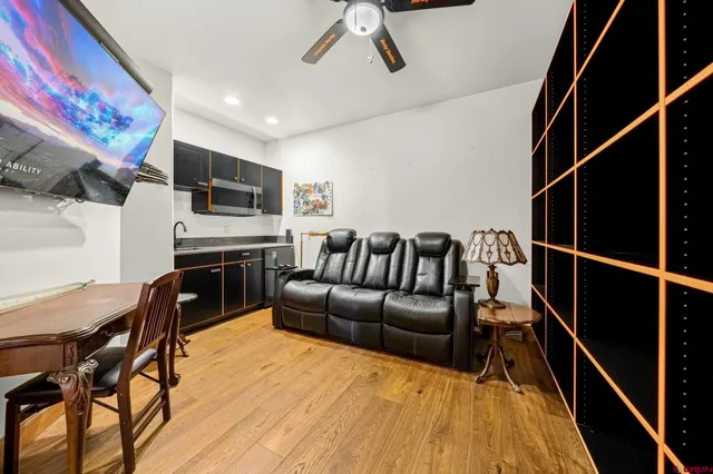 a large kitchen with kitchen island granite countertop a large window and stainless steel appliances