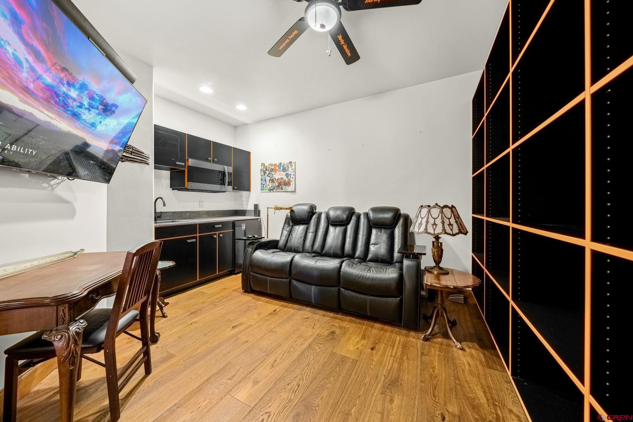 616 Cole Ranch Road Durango, CO 81303 - Photo 31 of 43 a living room with furniture a flat screen tv and kitchen view
