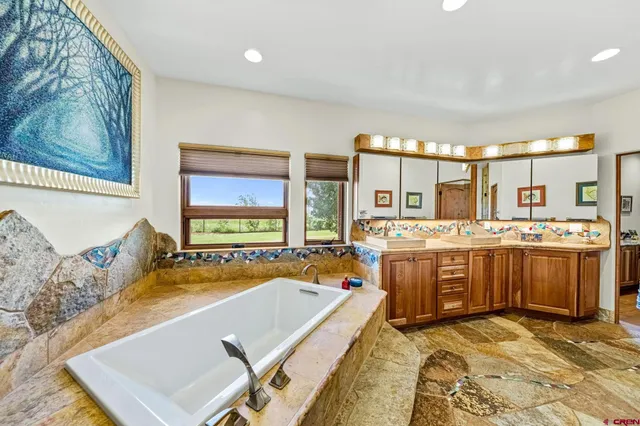 a view of a patio with couches and chairs under an umbrella