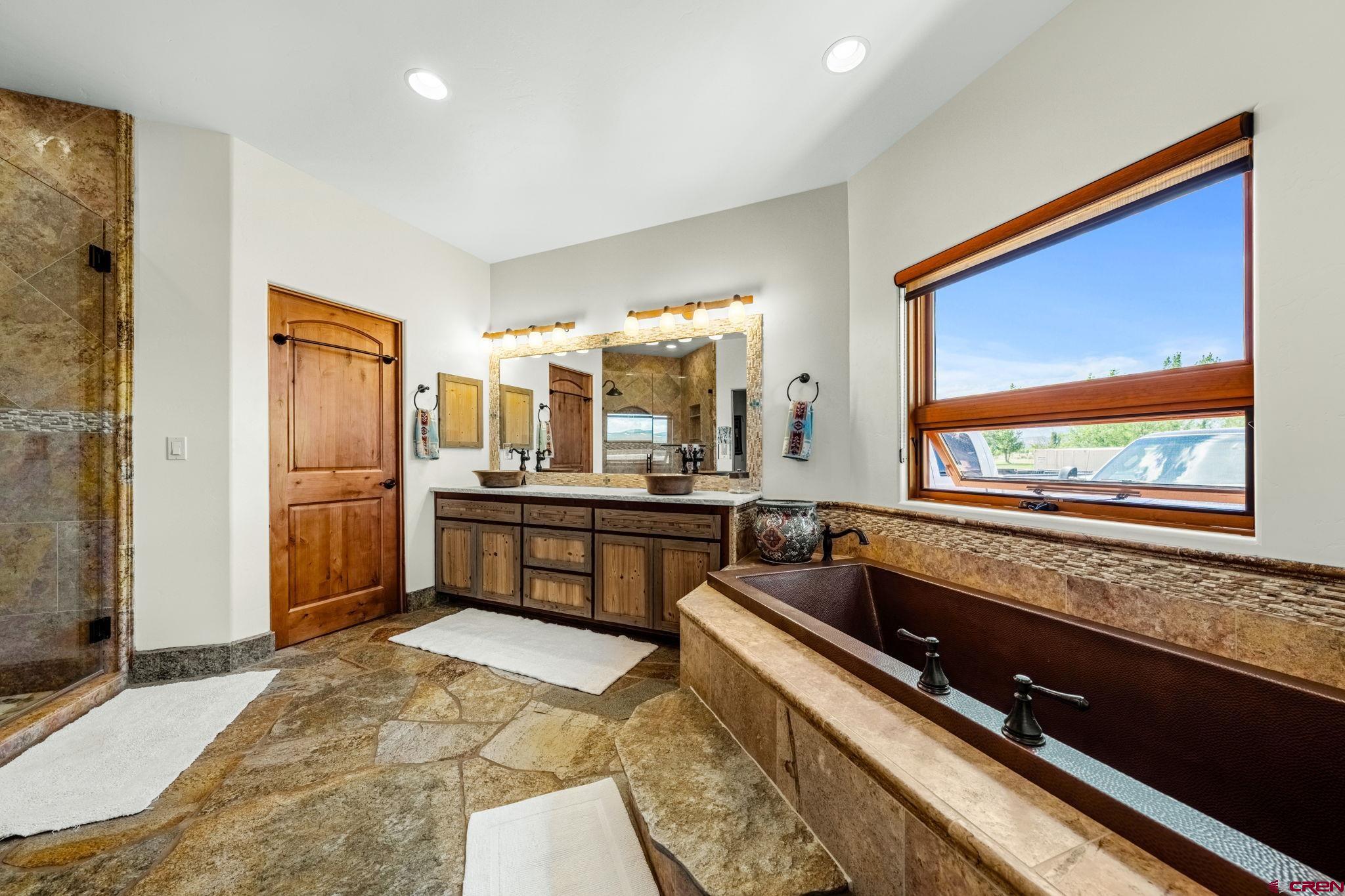 616 Cole Ranch Road Durango, CO 81303 - Photo 33 of 43 a large kitchen with kitchen island granite countertop a large window and stainless steel appliances
