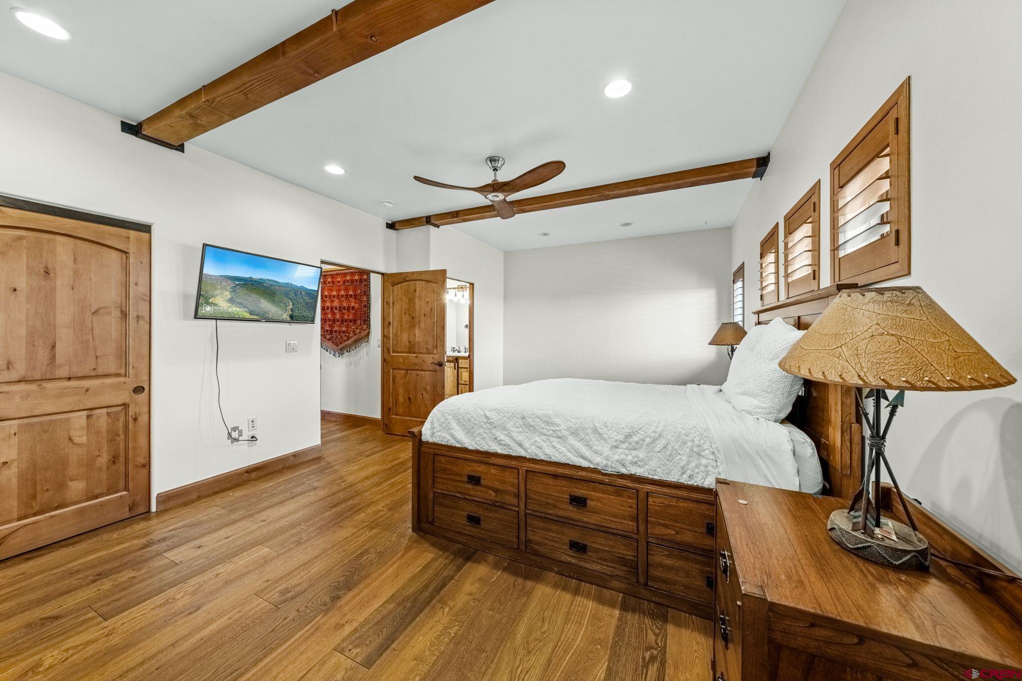 616 Cole Ranch Road Durango, CO 81303 - Photo 35 of 43 a bedroom with a bed and a flat screen tv