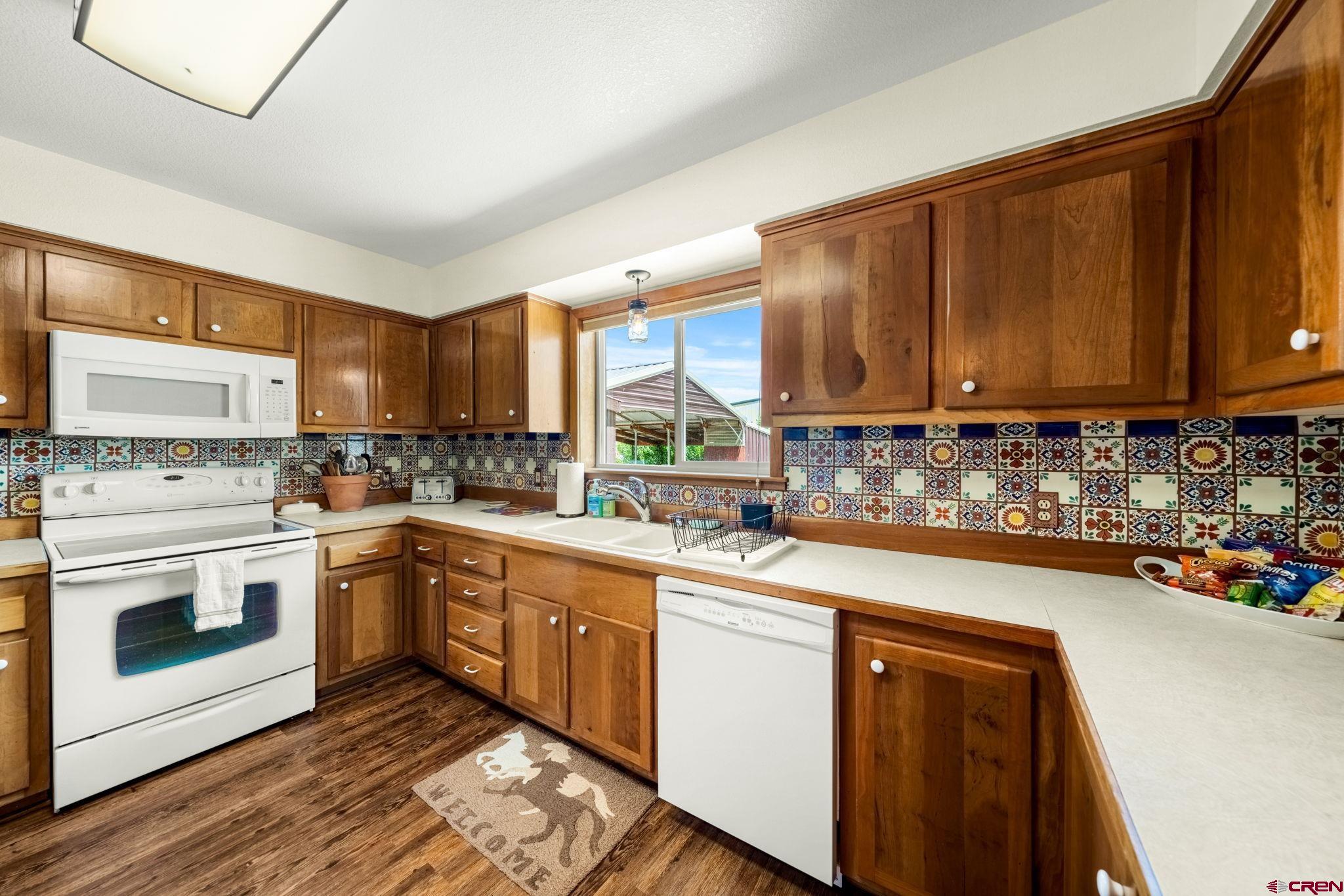 616 Cole Ranch Road Durango, CO 81303 - Photo 37 of 43 a kitchen with stainless steel appliances granite countertop a sink stove and cabinets