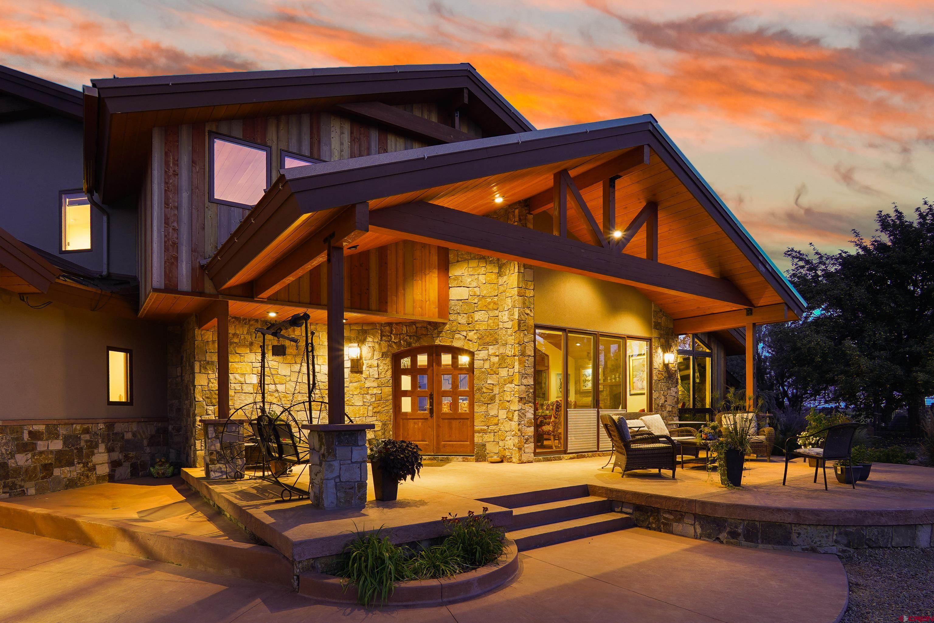 616 Cole Ranch Road Durango, CO 81303 - Photo 10 of 43 a patio with a table and chairs and a barbeque