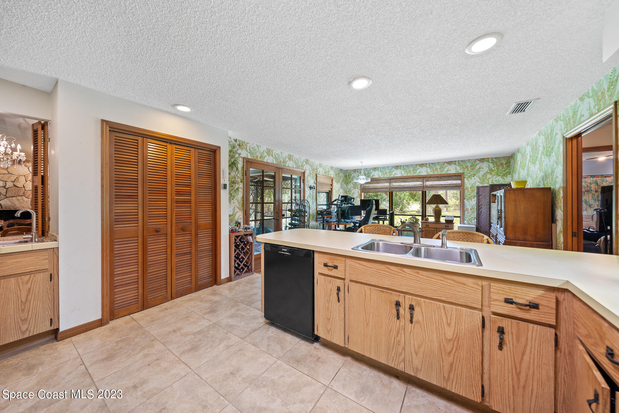 3836 Hield Road Northwest Palm Bay, FL 32907 - Photo 14 of 55 a kitchen with stainless steel appliances granite countertop a sink and cabinets