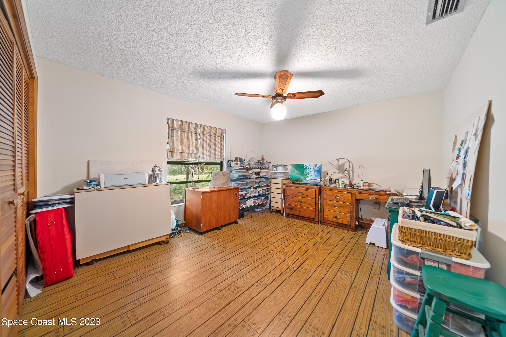 3836 Hield Road Northwest Palm Bay, FL 32907 - Photo 30 of 55 a living room with furniture kitchen view and a wooden floor
