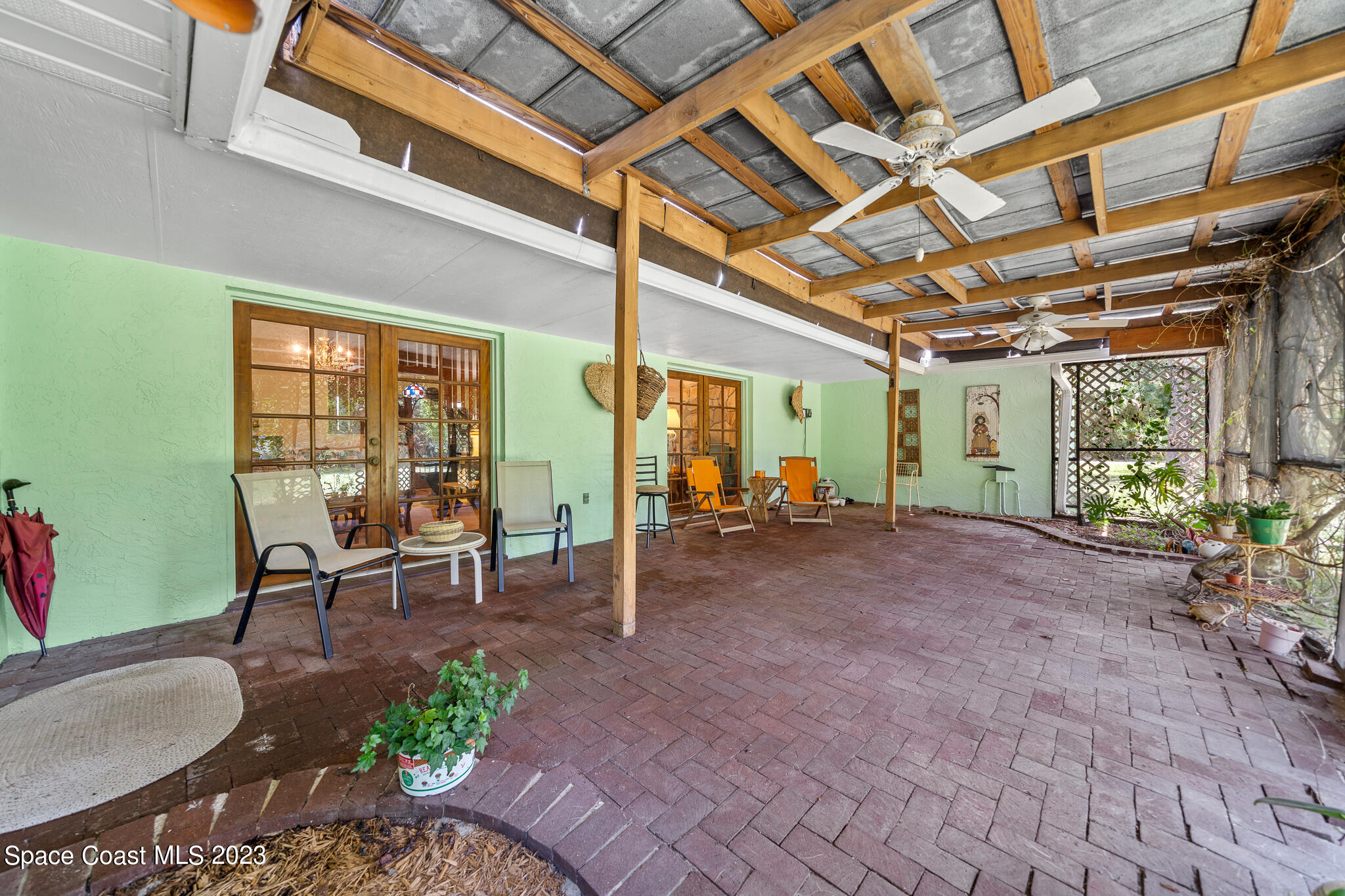 3836 Hield Road Northwest Palm Bay, FL 32907 - Photo 31 of 55 a view of a porch with furniture and a backyard