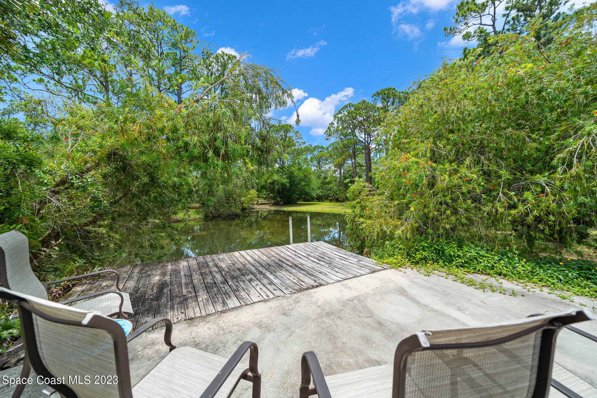 3836 Hield Road Northwest Palm Bay, FL 32907 - Photo 38 of 55 Deck Overlooking Stocked Fish Pond