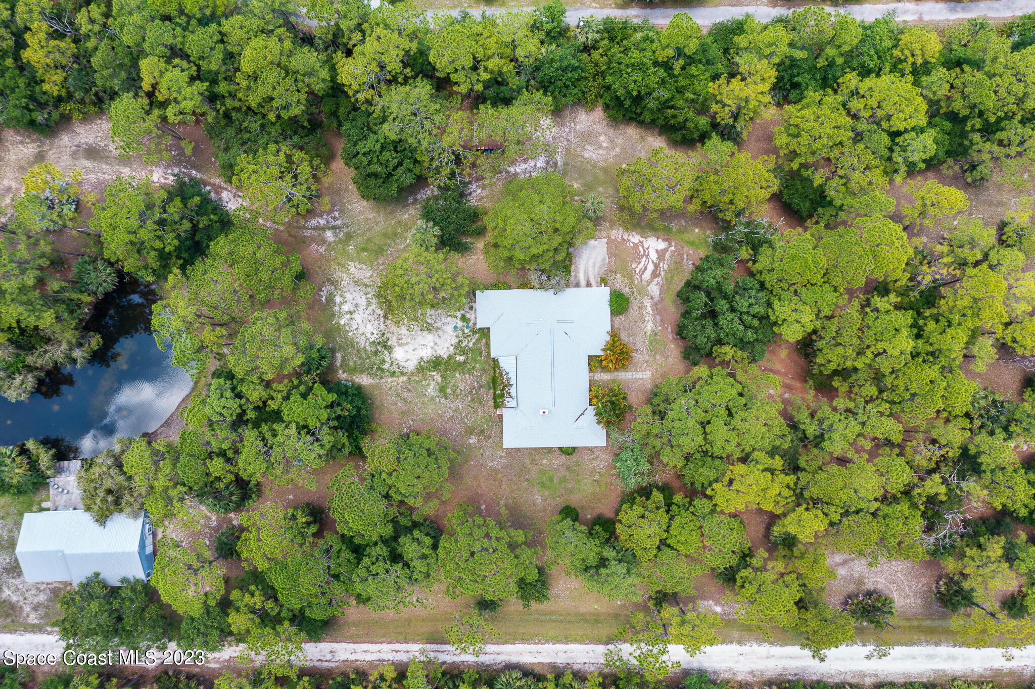 3836 Hield Road Northwest Palm Bay, FL 32907 - Photo 52 of 55 an aerial view of a house with a yard and lake view