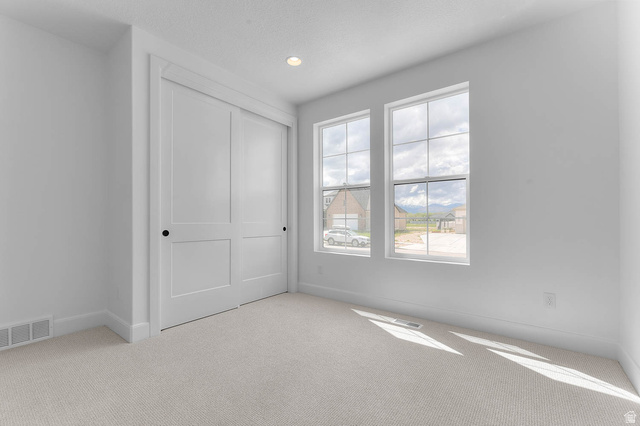 11711 South Halls Crk Road Draper, UT 84020 - Photo 10 of 31 Unfurnished bedroom featuring light carpet, a closet, and recessed lighting