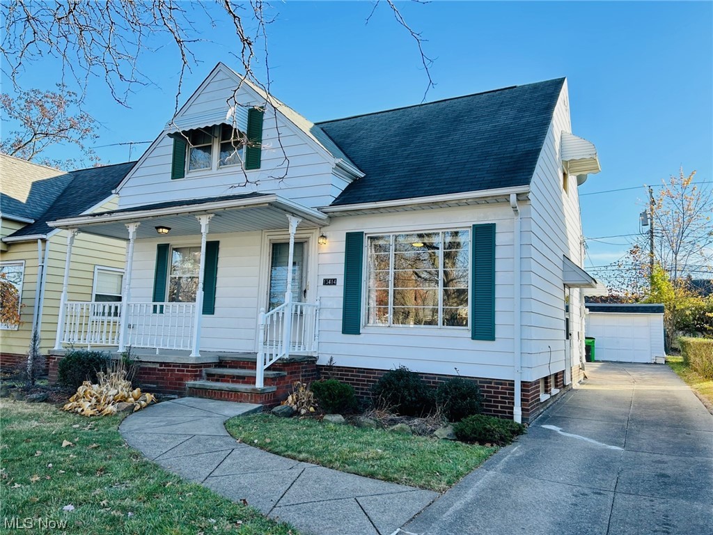 Bungalow featuring a garage and covered porch