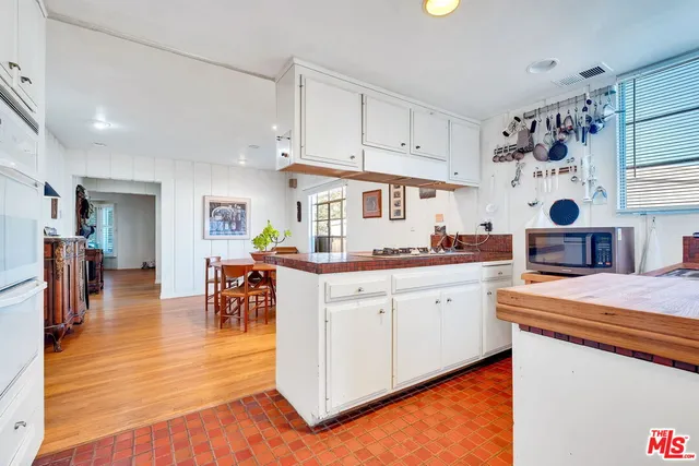 a kitchen with stainless steel appliances kitchen island granite countertop a sink and cabinets