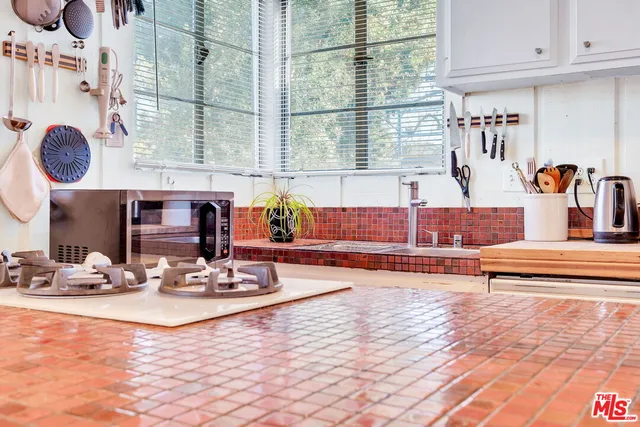 a kitchen with stainless steel appliances a refrigerator and cabinets