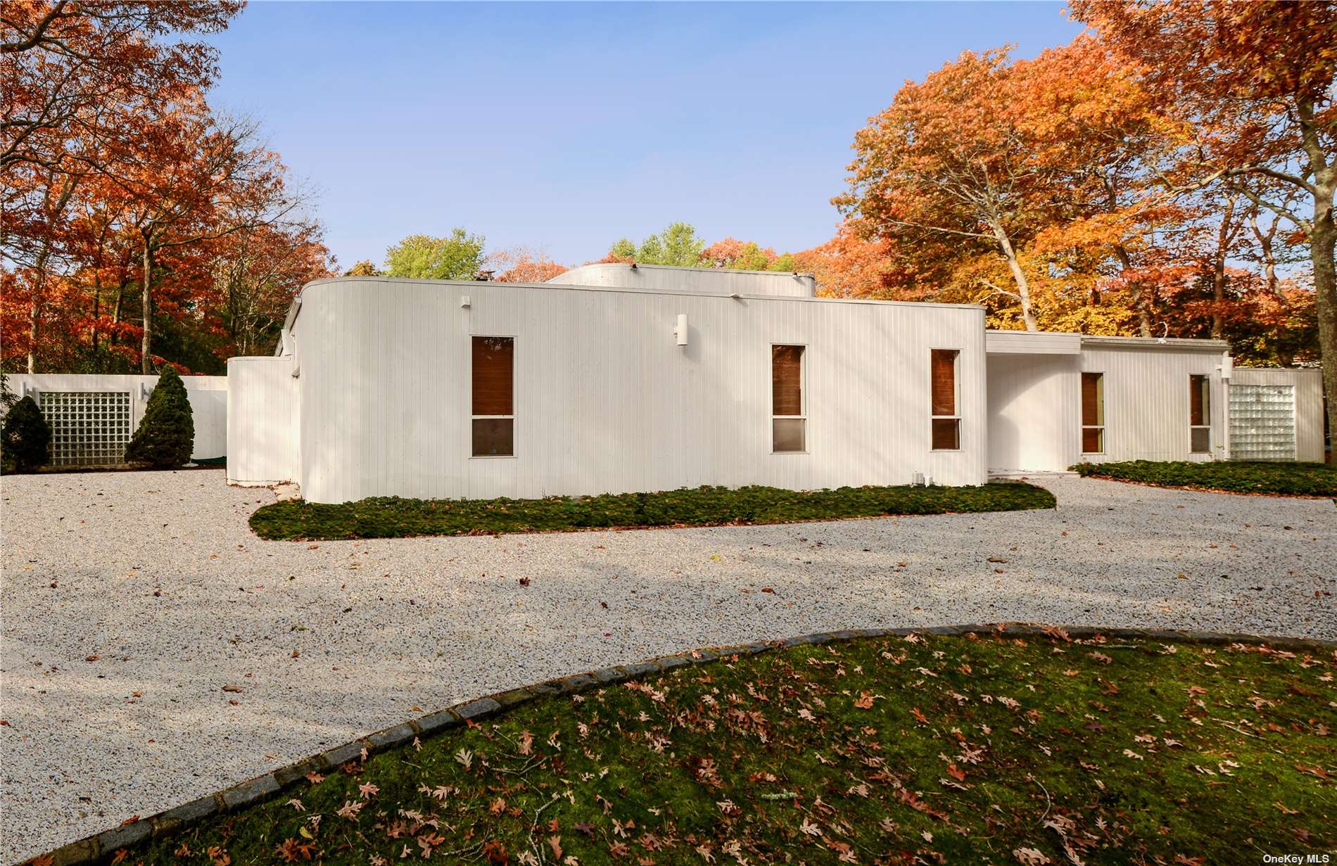 a view of a white house with a yard