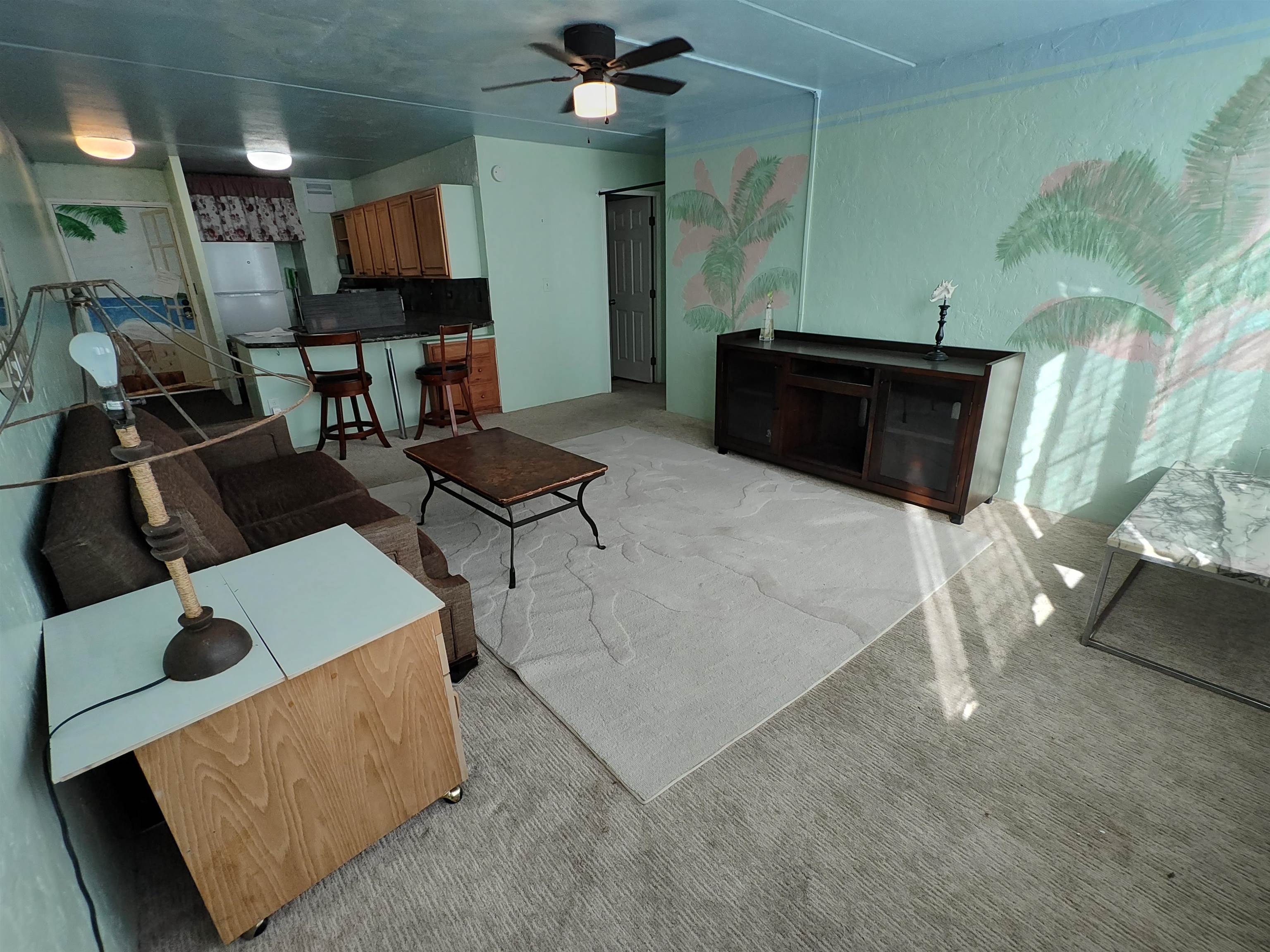 111 Kahului Beach Road, Unit C401 Kahului, HI 96732 - Photo 2 of 12 a living room with furniture and a fireplace