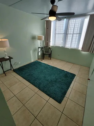 a view of a porch with furniture and floor to ceiling window