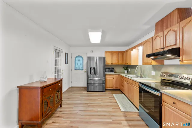 a view of room with wooden floor and ceiling fan