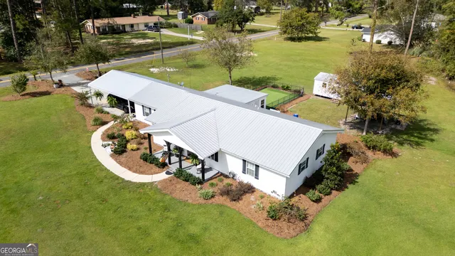 an aerial view of a house with swimming pool and lake view